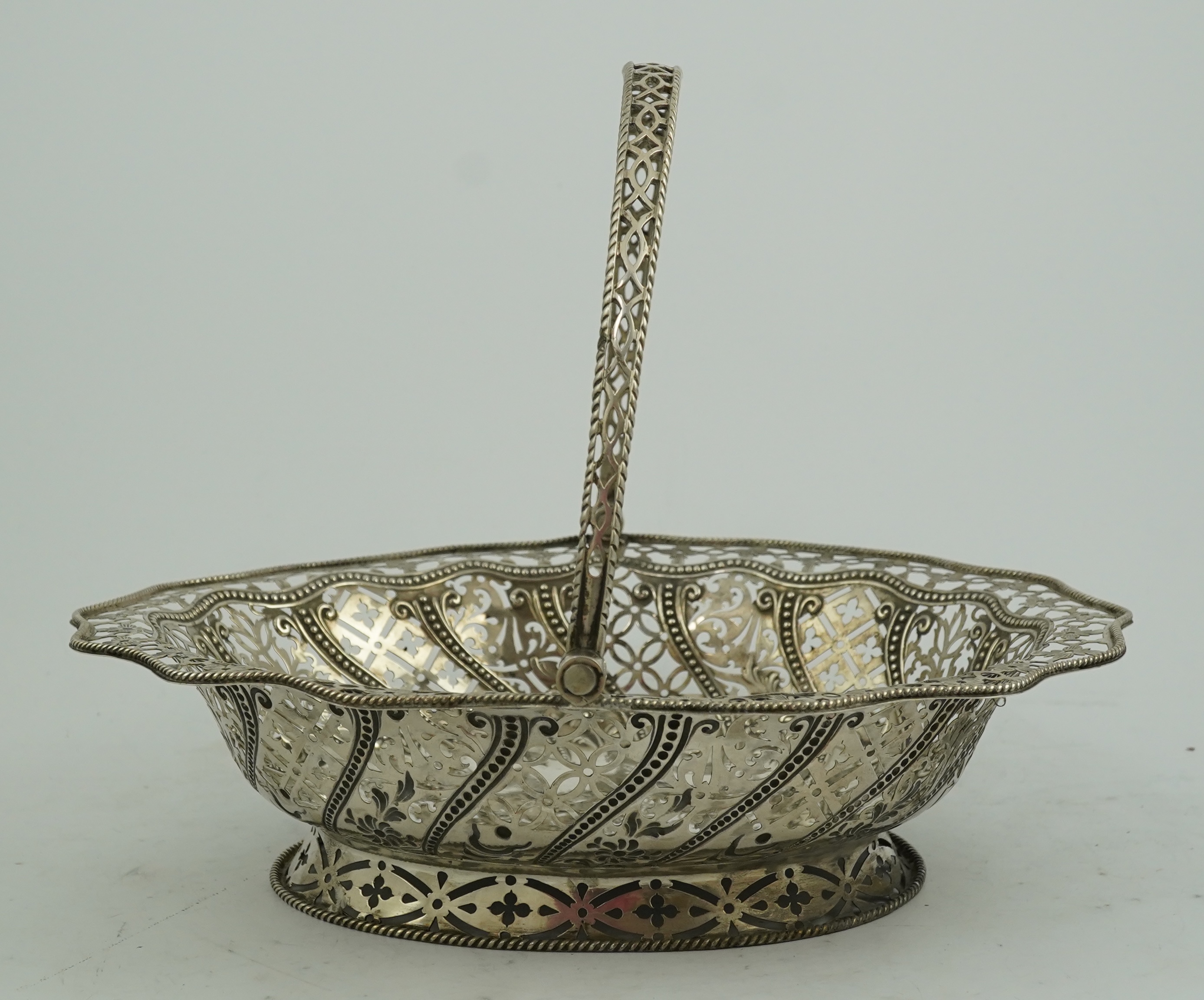 A George III pierced repousse silver cake basket